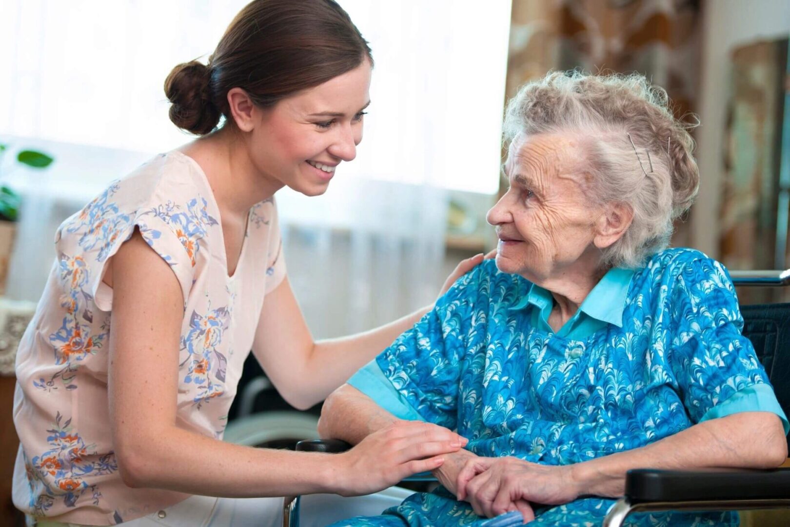 A woman and an old lady smiling for the camera.